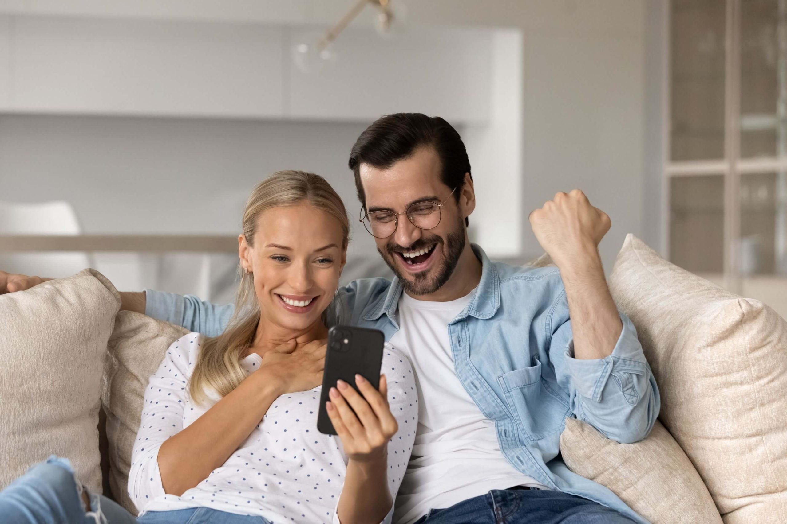 Happy couple getting news of no deposit home loan approval