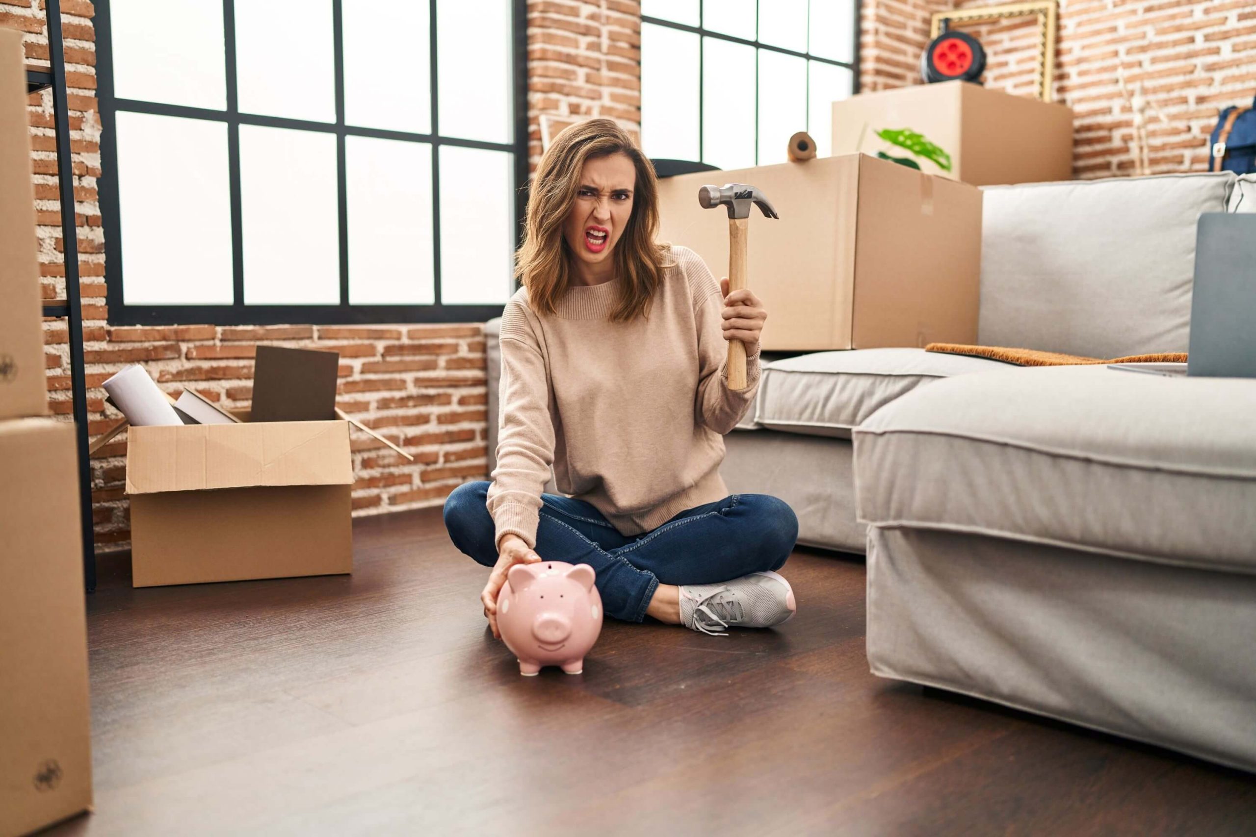 Woman stopping from breaking piggy bank after hearing about no deposit home loans